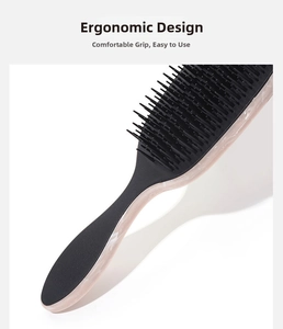 Close-up of ergonomic marble texture handle on a detangling hairbrush for scalp massage