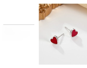 Detail showing the multi-layer gold plating on these red heart-shaped stud earrings