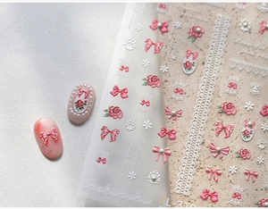 Detail shot of TL-310 3D nail art stickers with pink roses, bows, and lace designs