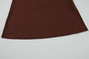 Detail shot of the fine double-needle stitching on the dark brown knit dress hemline