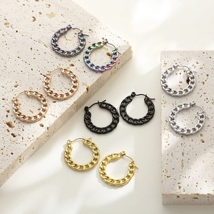 Hollow chain link hoop earrings in gold silver and multi-colors on stone background