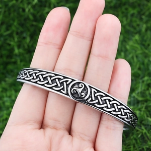 Unisex stainless steel open cuff bracelet with Celtic knot patterns and triskelion symbol