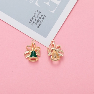 Detail of green enamel Christmas bell charms with gold bow accents for DIY jewelry