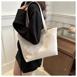 White large capacity tote bag shown on model shoulder for daily casual commuting