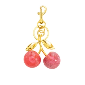 Chic pink glitter resin cherry keychain with golden metal clasp on white background
