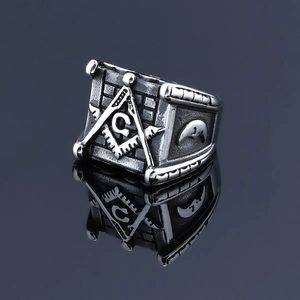 Macro view of Masonic ring with compass, letter G, and moon relief in retro steel