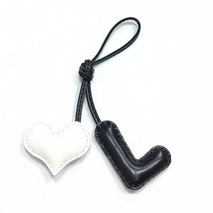 Handmade leather heart and letter L bag charm with stitched edges on black cord