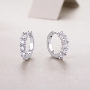 Detail view of S925 sterling silver hoop earrings with shimmering moissanite inlay