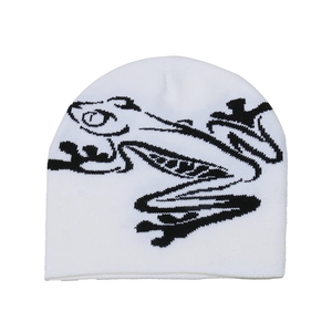 Detail shot of white knitted beanie featuring black frog art embroidery and fine texture