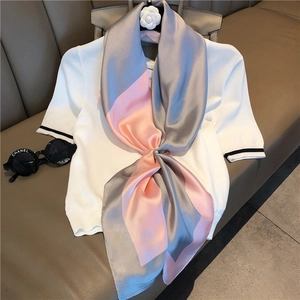 Detail of gray and pink satin scarf with premium luster and elegant pearl fastener