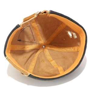 Black vintage miki hat with contrast mustard lining and distressed patchwork details