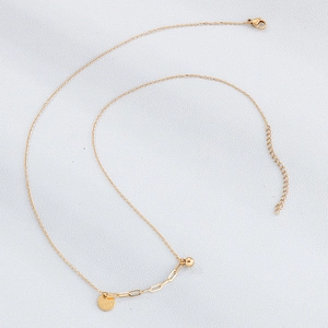 Detailed view of golden stainless steel necklace with engraved Good Luck round pendant