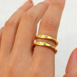 Detail of 18K gold plated titanium steel rings with Taurus and Sagittarius zodiac symbols