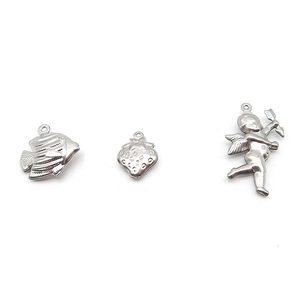 Detail of silver hollow charms in fish, strawberry and cupid shapes for DIY jewelry