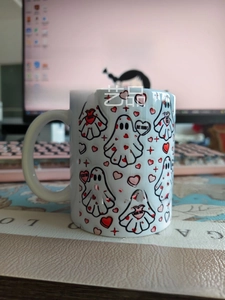Close-up of 3D Spooky Ghost and hearts pattern printed on a ceramic Halloween coffee mug