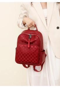 Detailed macro view of the red checkered pattern and PU leather texture on the backpack