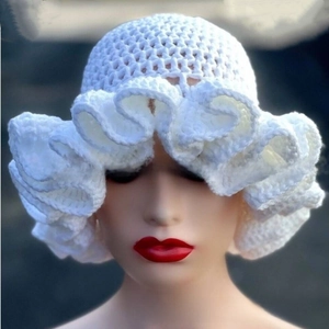 Detail shot of pure white handcrafted crochet hat with oversized ruffled wavy brim