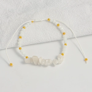 Detail of bohemian handmade beaded bracelet with white natural stones and adjustable cord