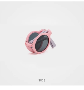 Detail view of foldable pink round sunglasses for kids showing its compact portable design