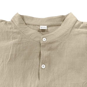 Detail shot of khaki linen shirt mandarin collar and buttons on cotton fabric