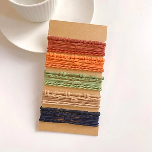 Close-up of high-elasticity hair ties set in various colors on kraft paper cards