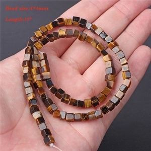 Macro shot of 4x4mm square tiger eye stone beads on a 15-inch string for DIY jewelry