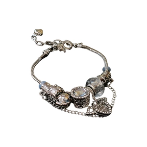 Silver charm bracelet featuring snake chain with sparkling hearts and crystals