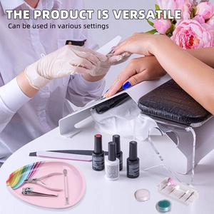 Manicure tool set with white hand rest, pink tray, and stainless steel nail clippers