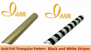 Detail of gold foil triangle patterns and black-white stripe heart gift wrapping paper