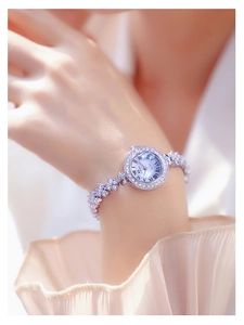 Detailed view of silver quartz watch with rhinestone bezel on female wrist