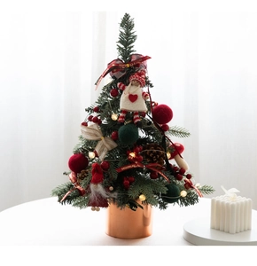 Close-up of a 60cm mini Christmas tree with red berries, pinecones, and warm LED lights