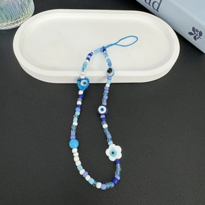 Bohemian evil eye phone charm with blue resin beads and heart flower accents