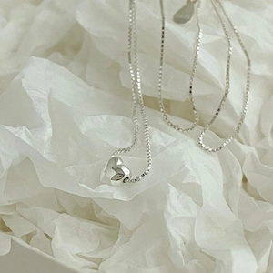 Minimalist 925 sterling silver heart pendant necklace on a clean white paper background