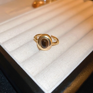 Detail of adjustable dragon ring with oval brown stone and bamboo-style carvings