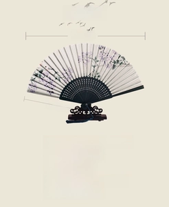 Detail of Chinese folding fan with purple floral print and vintage black wooden stand
