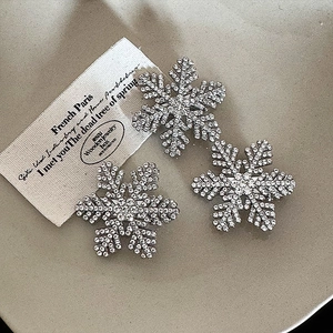Set of three silver snowflake hair clips with sparkling crystals for winter styling