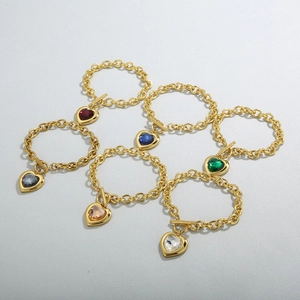 Golden OT buckle heart bracelets with various colored crystals in a neat row