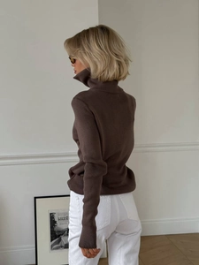 Detail of slim-fit brown ribbed knit sweater showing back texture and soft drape