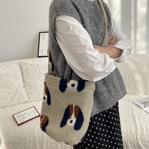 Close-up of fluffy leopard faux fur shoulder bag with cute cartoon dog pattern detail