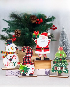 Detailed view of festive wooden Christmas table ornaments featuring Santa and Snowman themes