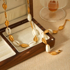 Elegant gold stainless steel necklace and bracelet set with natural cowrie shell pendants