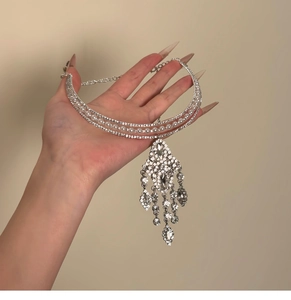 Macro shot of silver rhinestone tassel choker with pearls and cascading drop pendants