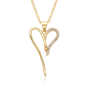 Close-up of a 18K gold plated hollow heart pendant with shimmering white zircon stones