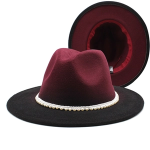 Detail of wide brim fedora with burgundy crown, black brim and white pearl hatband