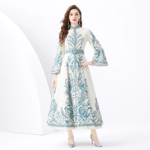 Floral print maxi dress with stand collar and flared sleeves on architectural backdrop