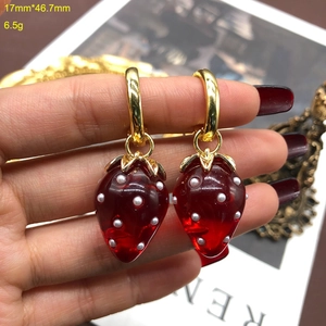 Detail shot of strawberry drop earrings with size 17x46.7mm and weight 6.5g specs
