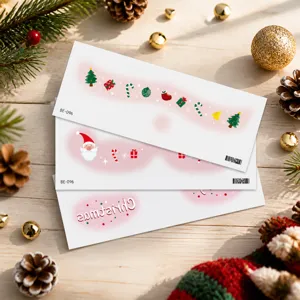 Macro detail of Christmas themed face gems featuring Santa and festive star patterns