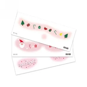 Macro detail of Christmas themed face gems featuring Santa and festive star patterns