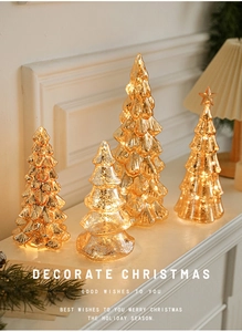 Golden mercury glass Christmas tree lights on white mantel with warm holiday glow