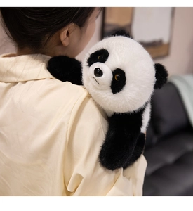 Close-up of a realistic giant panda plush toy with soft faux fur texture on a shoulder
